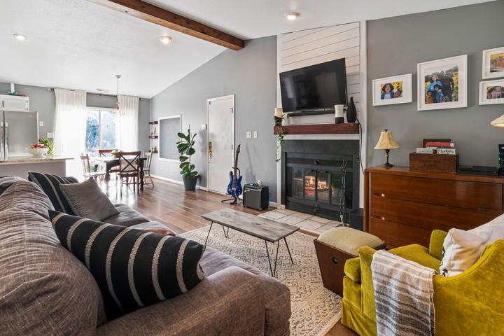 Fireplace and television in a living room with dark seating